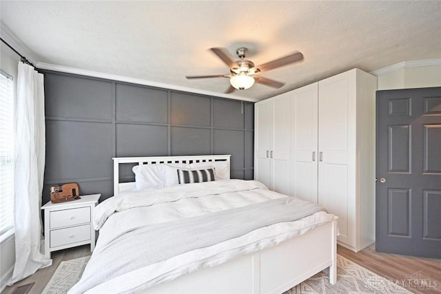 171 Pleasant Hill Blvd, Franklin, OH 45005 - bedroom with a ceiling fan, visible vents, wood finished floors, a closet, and a decorative wall
