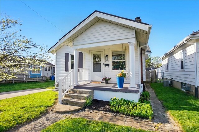 1708 Patterson Rd, Dayton, OH 45420 - view of front of property with a porch, a chimney, central AC, and a front yard