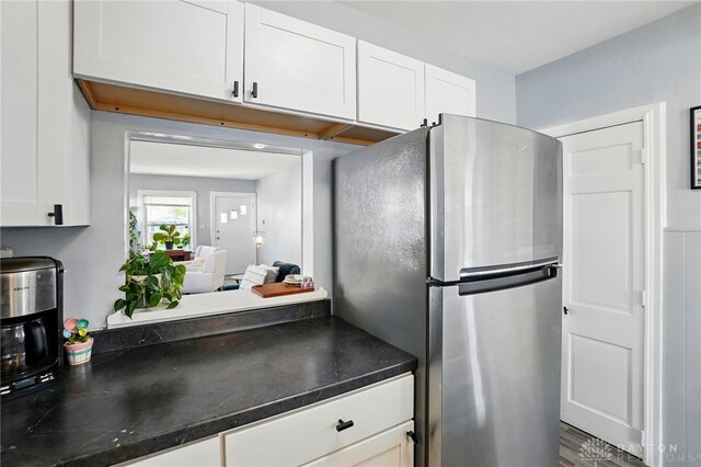 1708 Patterson Rd, Dayton, OH 45420 - kitchen with freestanding refrigerator, dark countertops, and white cabinetry