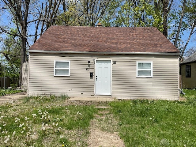 rear view of house with a shingled roof