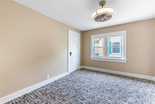 carpeted empty room with baseboards