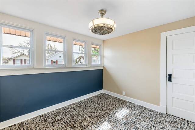 spare room featuring baseboards