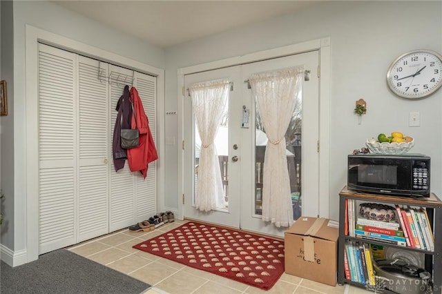 doorway to outside with tile patterned floors and french doors