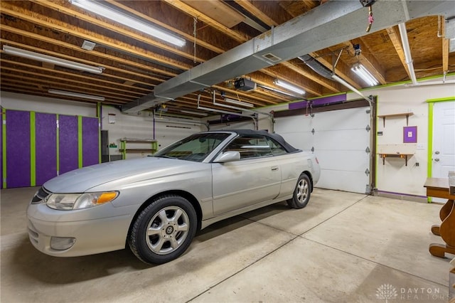 garage featuring a garage door opener and electric panel