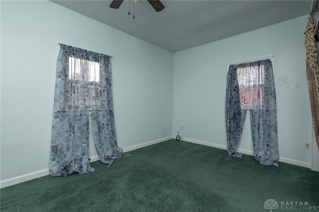 unfurnished room featuring a ceiling fan, carpet flooring, a wealth of natural light, and baseboards