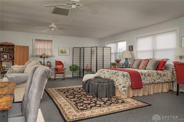 bedroom featuring baseboards, visible vents, a ceiling fan, and carpet