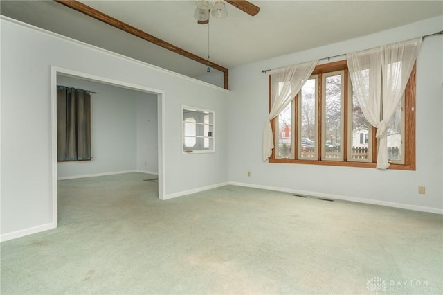 unfurnished room with baseboards, ceiling fan, and carpet