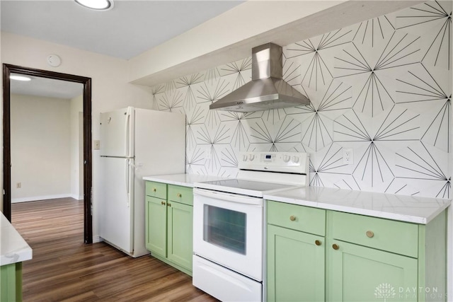 kitchen featuring dark wood-style flooring, tasteful backsplash, wall chimney range hood, white appliances, and green cabinetry