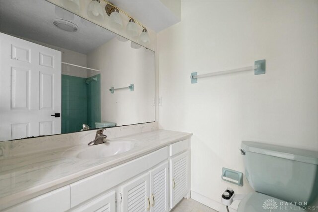 full bath featuring a shower, vanity, toilet, and tile patterned flooring