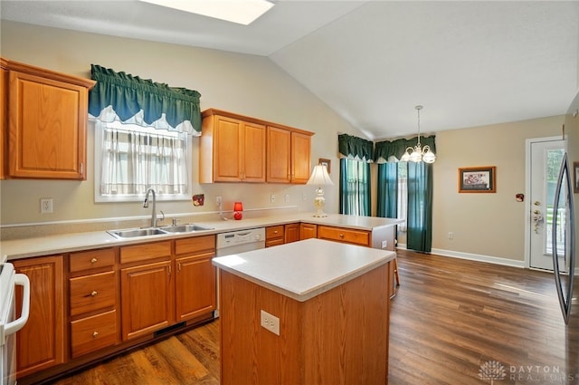 kitchen with lofted ceiling, dark wood-type flooring, light countertops, and a sink