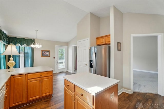 kitchen with stainless steel fridge, light countertops, a notable chandelier, dark wood-type flooring, and baseboards