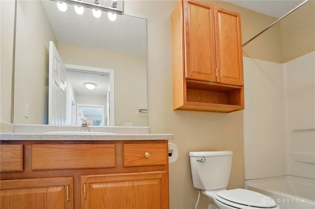 full bathroom featuring bathing tub / shower combination, toilet, and vanity