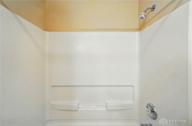 details featuring shower / washtub combination