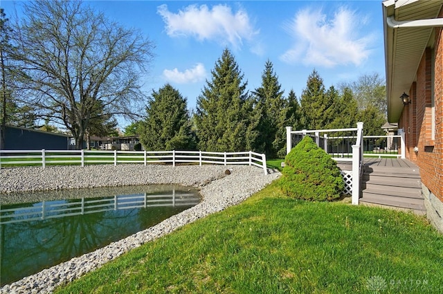 view of yard featuring a deck and fence