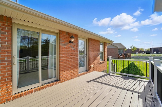 wooden deck featuring a yard