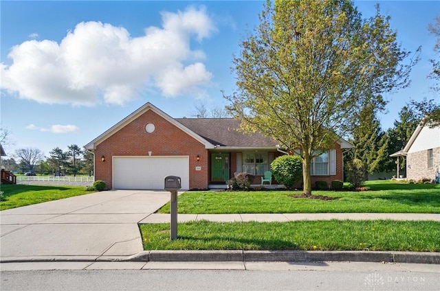 ranch-style home featuring a front yard, a garage, concrete driveway, and brick siding