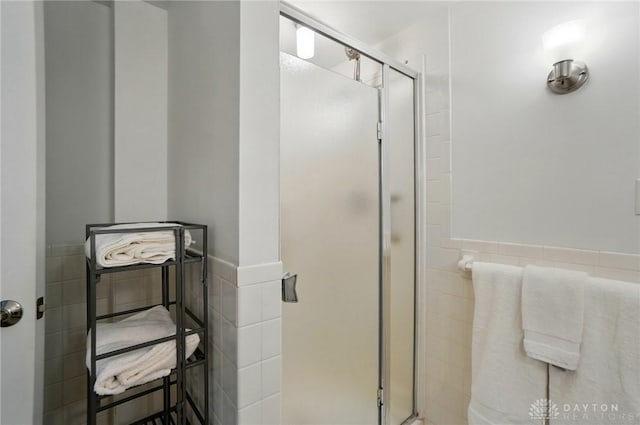 5017 Ackerman Blvd, Kettering, OH 45429 - full bathroom featuring tile walls, a shower stall, and wainscoting