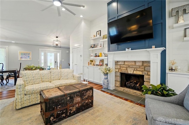 5017 Ackerman Blvd, Kettering, OH 45429 - living area featuring light wood-style flooring, a ceiling fan, a stone fireplace, recessed lighting, and lofted ceiling