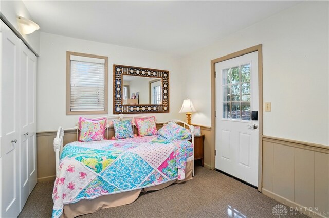 5017 Ackerman Blvd, Kettering, OH 45429 - carpeted bedroom with a wainscoted wall, multiple windows, and a closet