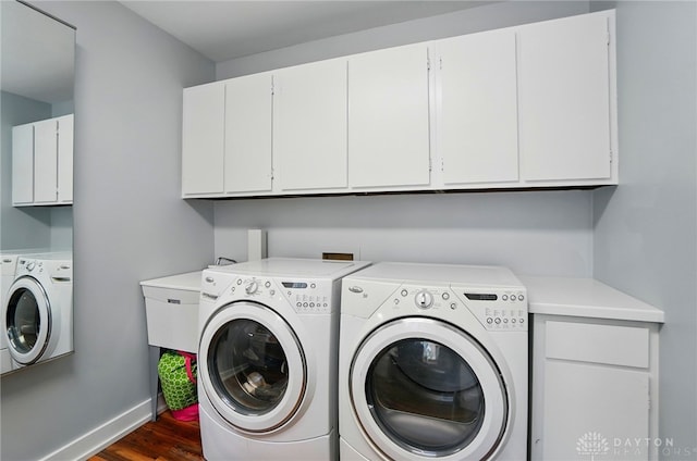 5017 Ackerman Blvd, Kettering, OH 45429 - washroom with separate washer and dryer, cabinet space, dark wood-style flooring, and baseboards