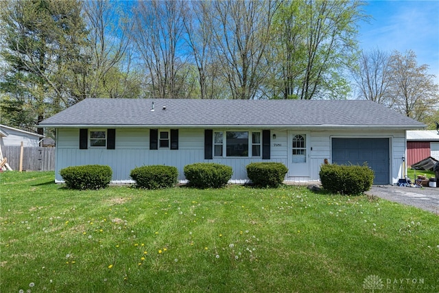 7351 Willow Dr, Blanchester, OH 45107 - ranch-style house with aphalt driveway, roof with shingles, a front yard, an attached garage, and fence