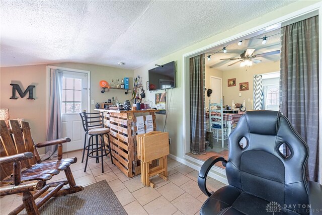 7351 Willow Dr, Blanchester, OH 45107 - living room with a textured ceiling, ceiling fan, a wealth of natural light, and lofted ceiling