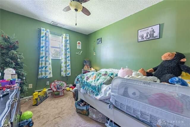 7351 Willow Dr, Blanchester, OH 45107 - bedroom featuring visible vents, ceiling fan, a textured ceiling, and carpet flooring