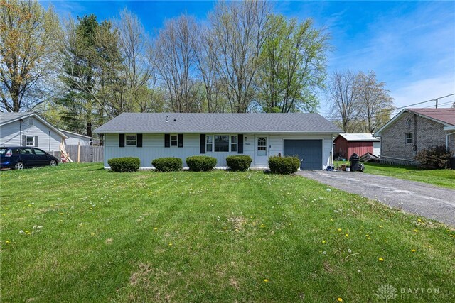 7351 Willow Dr, Blanchester, OH 45107 - ranch-style home featuring a garage, fence, driveway, and a front yard