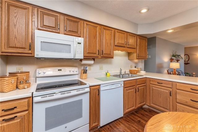 1823 Park Ave, Piqua, OH 45356 - kitchen with a sink, dark wood-style flooring, white appliances, brown cabinetry, and light countertops