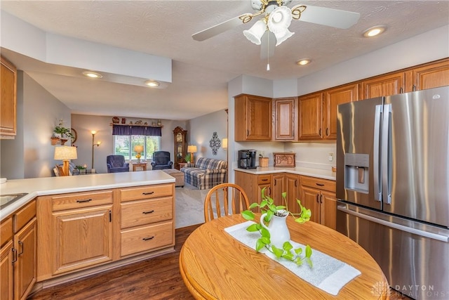 1823 Park Ave, Piqua, OH 45356 - kitchen featuring light countertops, dark wood-type flooring, open floor plan, stainless steel refrigerator with ice dispenser, and a ceiling fan