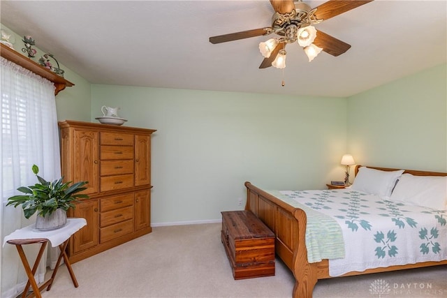 1823 Park Ave, Piqua, OH 45356 - bedroom with baseboards, a ceiling fan, and light carpet