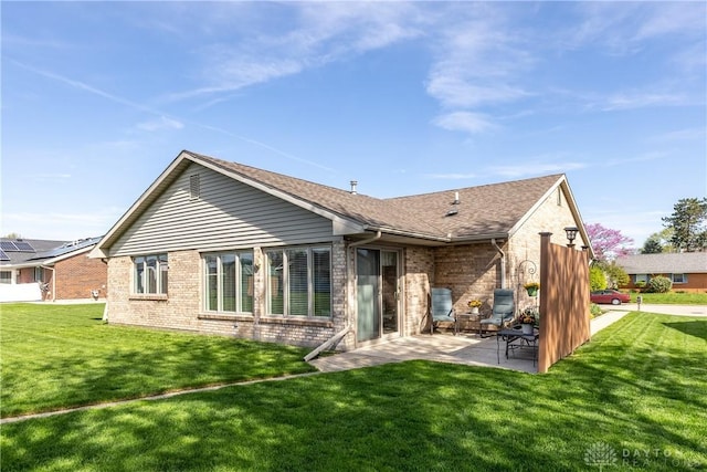 1823 Park Ave, Piqua, OH 45356 - rear view of house with a patio, brick siding, a yard, and roof with shingles