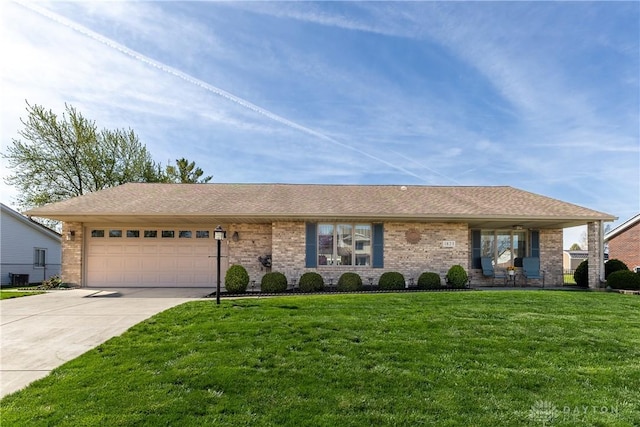 1823 Park Ave, Piqua, OH 45356 - ranch-style home with concrete driveway, a front yard, an attached garage, and brick siding