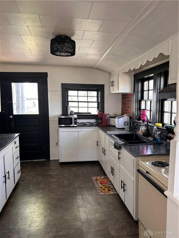 32 W 3rd St, West Alexandria, OH 45381 - kitchen with electric range, dark countertops, stainless steel microwave, a sink, and extractor fan