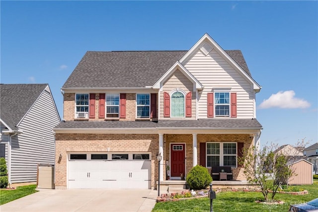 view of front facade featuring concrete driveway, a shingled roof, an attached garage, and covered porch