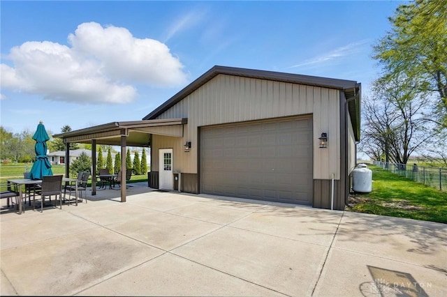 detached garage featuring fence
