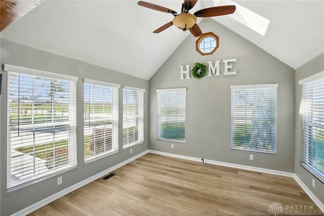 spare room featuring plenty of natural light, a ceiling fan, and a skylight
