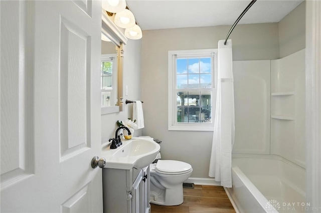 full bathroom featuring vanity, toilet, shower / tub combo, baseboards, and wood finished floors