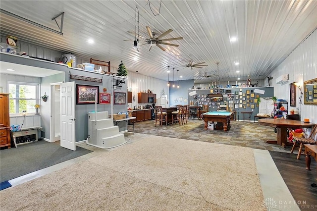 interior space featuring billiards, a ceiling fan, and a wall mounted AC