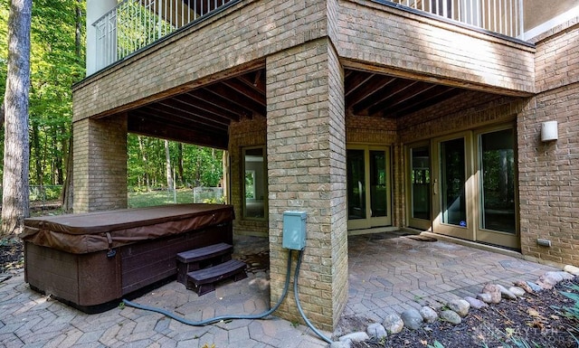 view of patio / terrace with french doors and a hot tub