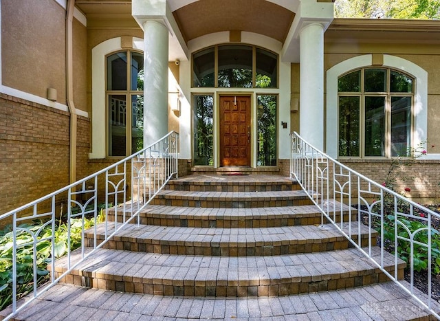 property entrance with stucco siding