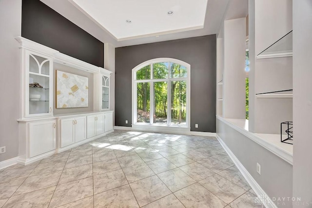 interior space featuring marble finish floor and baseboards