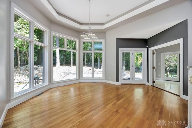 interior space featuring an inviting chandelier, ornamental molding, light wood finished floors, baseboards, and visible vents