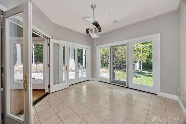 unfurnished sunroom with french doors