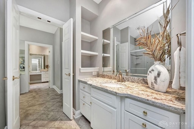bathroom with vanity and baseboards