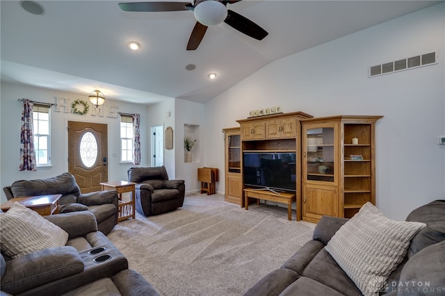living room with light colored carpet, ceiling fan, visible vents, and lofted ceiling