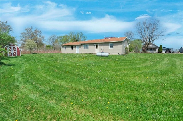 back of property featuring a storage unit, an outbuilding, and a yard
