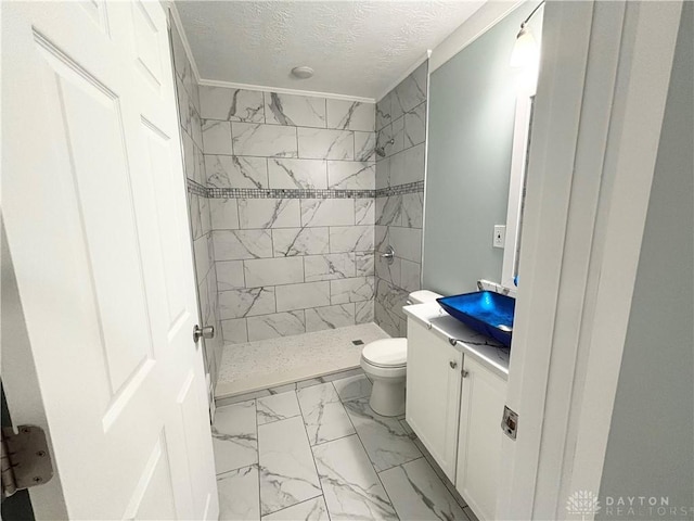 bathroom featuring a shower stall, marble finish floor, toilet, vanity, and a textured ceiling