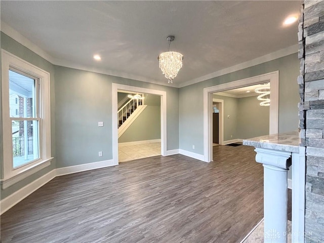 interior space featuring baseboards, a notable chandelier, stairs, and dark wood-style flooring