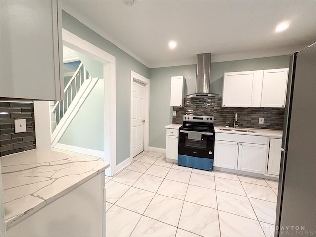 kitchen with a sink, wall chimney exhaust hood, backsplash, white cabinets, and appliances with stainless steel finishes